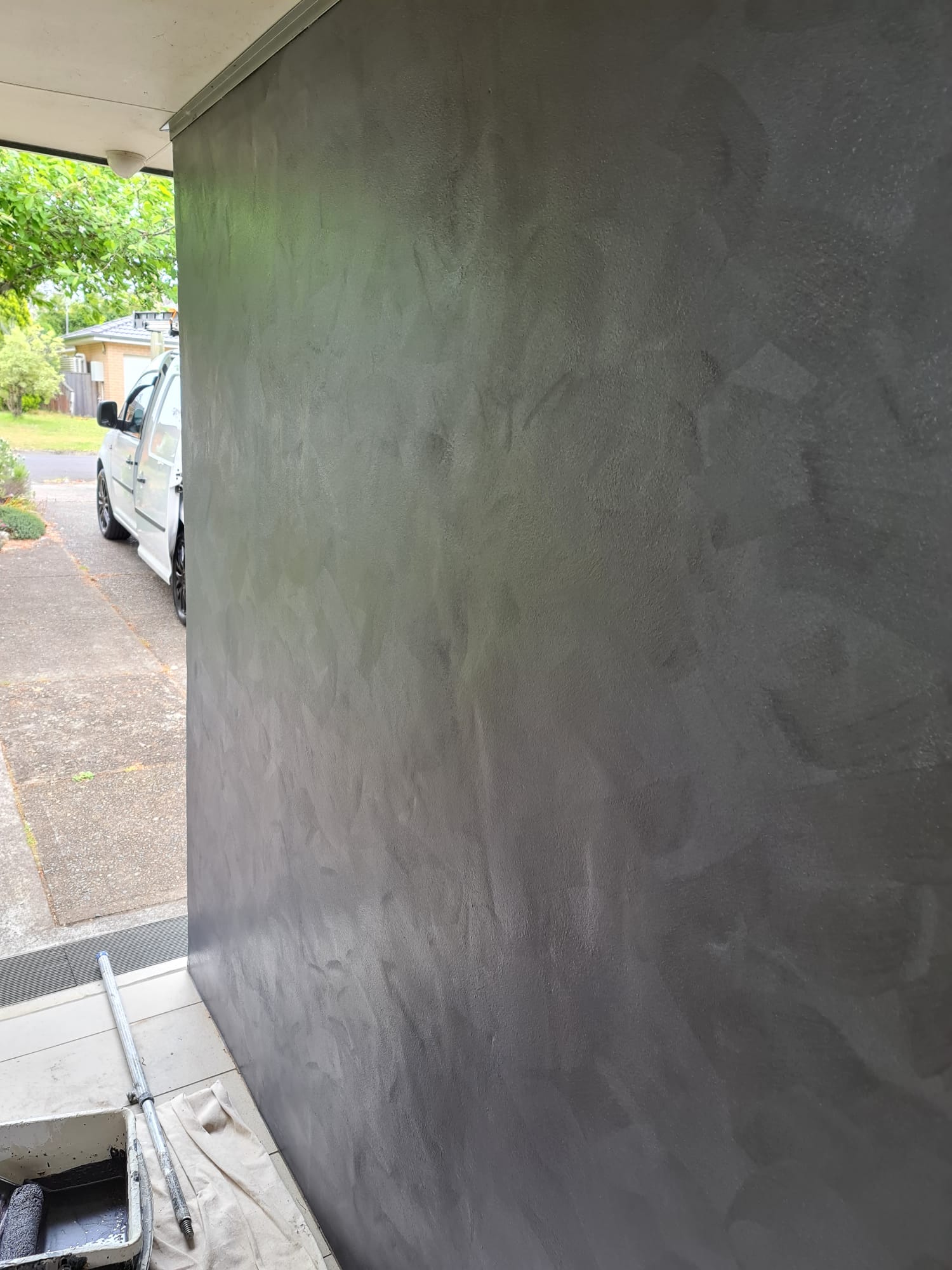 Dramatic charcoal metallic feature wall with a hand-applied finish