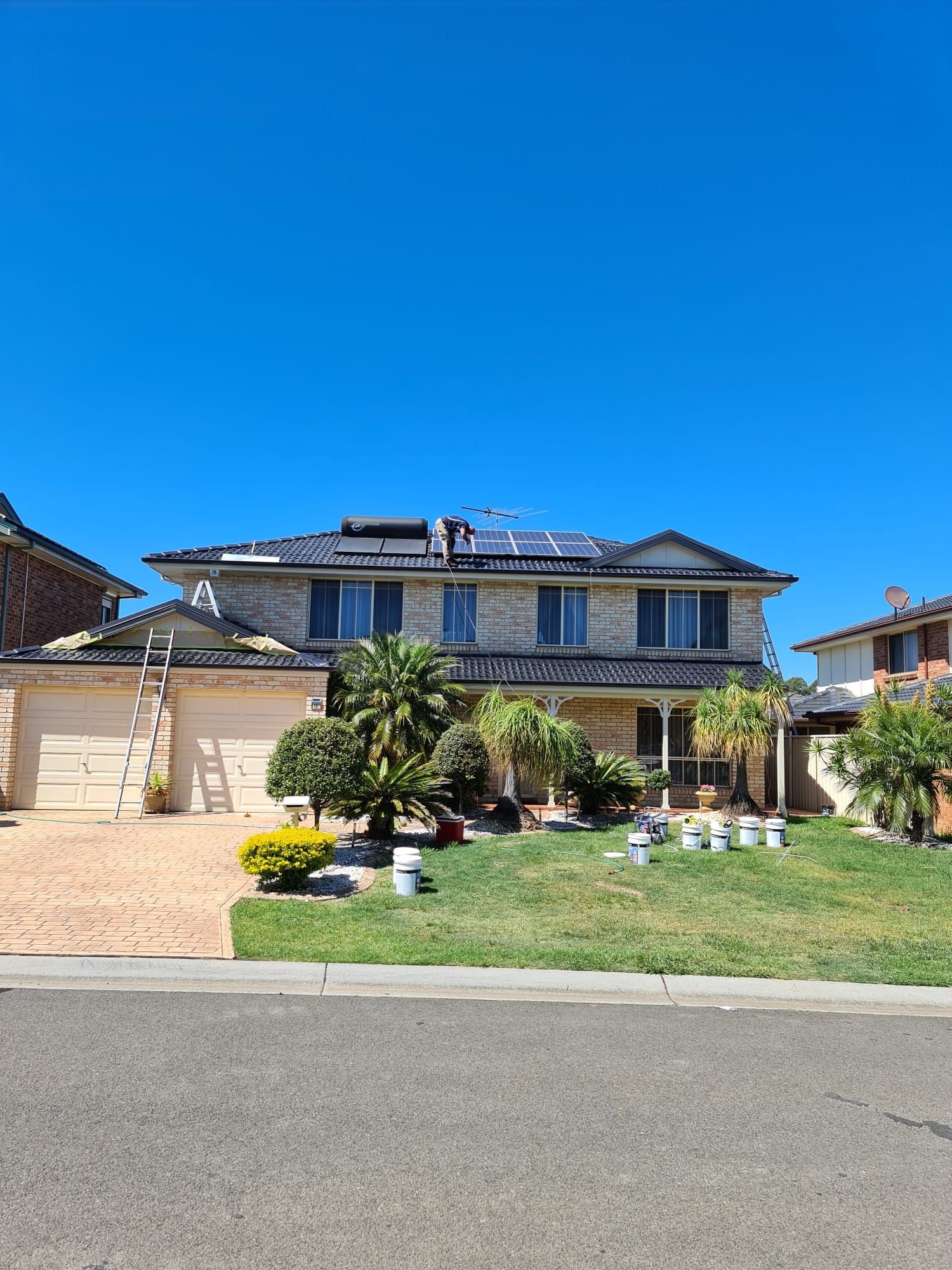 Repainted brick family home under a clear blue Sydney sky