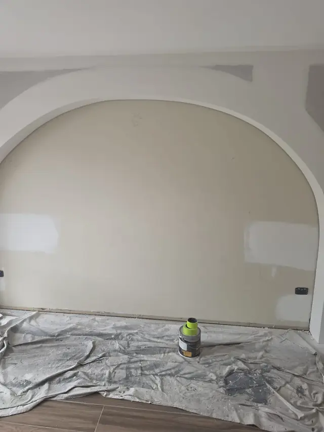 Maestro Painting interior painter applying a smooth roller coat to a wall in a bright Sydney living room