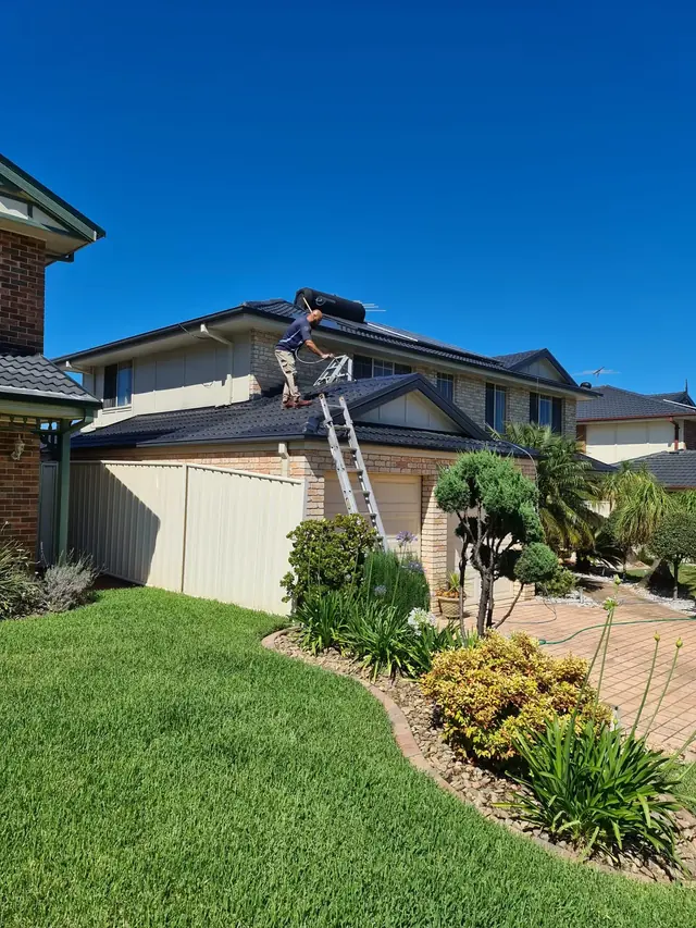 Restored and freshly coated tiled roof on a Sydney home with clean ridge capping